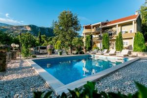 a swimming pool in front of a house at Villa Besha in Herceg-Novi