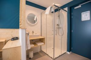 a bathroom with a shower and a sink at Hôtel Café Miramar in Le Grau-du-Roi +37 photos
