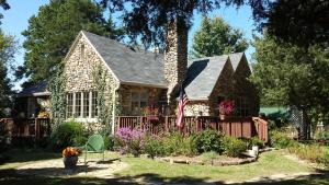 a house with a flag in the front yard at Rock Cottage Gardens B&B in Eureka Springs