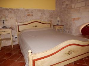 a bedroom with a wooden bed with two night stands at Case Vacanza ARCO SANT'ANTONIO in Bisceglie