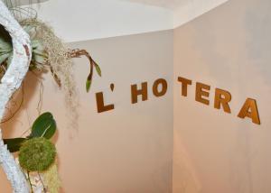 a wall with the words i htec on it at Hotel l'Hotera in Cannes