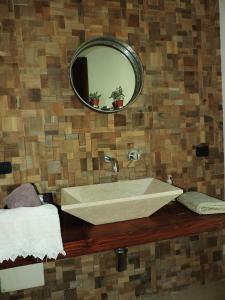 a bathroom with a sink and a mirror at B&B Danonna in Ittiri