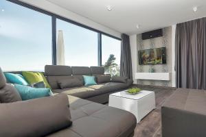 a living room with a couch and a table at Villa Selina - Nera in Makarska