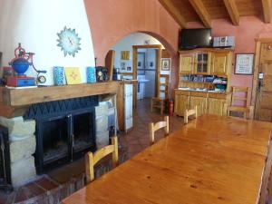a living room with a fireplace and a table at Hostal Rural Casa Pedro in San Martín de Unx