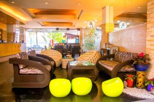 a restaurant with couches and chairs and a table at Baan Boa Resort in Patong Beach