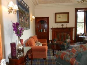 a living room filled with furniture and a fire place at Mansfield Castle Hotel in Tain