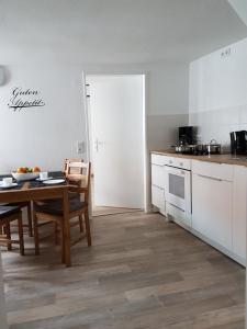 a kitchen with a table and a dining room at Köpi Appartements in Goslar