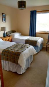 a hotel room with two beds and a window at 7 Habost in Balallan