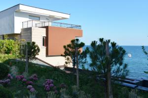 a house on the side of a hill next to the water at Akrotiriya Sea View in Nesebar