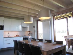a kitchen with a large wooden table and chairs at Allongueroye in Houffalize