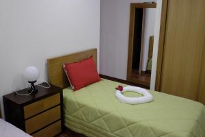 a bedroom with a green bed with a red pillow at Casa Lagar in Vale de Cambra +38 photos