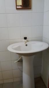 a white sink in a bathroom with a mirror at Isuruma Rest in Kataragama