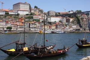 dos barcos en el agua con una ciudad en el fondo en Cozy Flat Porto Downtown, en Oporto