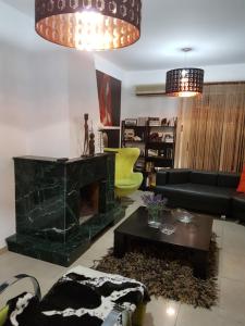 a living room with a couch and a fireplace at Villa Galleria in Perivolia