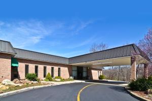 a large brick building with a road in front of it at Pocono Resort & Conference Center - Pocono Mountains in Lake Harmony
