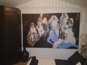 a painting of a group of people on a wall at Villa Galleria in Perivolia