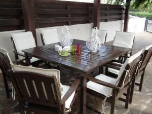 a wooden table with chairs and two vases on it at Villa Galleria in Perivolia