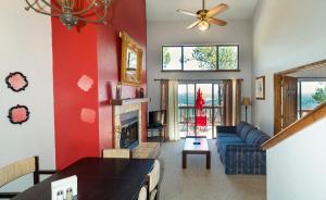 a living room with red walls and a blue couch at Tiara Del Sol in Ruidoso