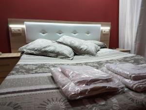a bed with plastic sheets and pillows on it at Hostal los nogales in Cangas del Narcea