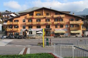 a large building with balconies on the side of a street at Hotel Edelweiss in Passo del Tonale