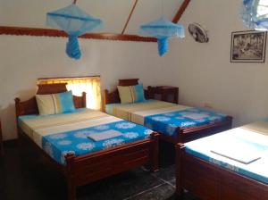 A bed or beds in a room at Suduweli Beauties of Nature - Yala