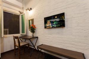 
a living room with a painting on the wall at Luxury Backpakers Hotel in Hanoi
