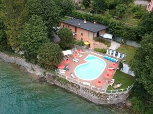 an aerial view of a house with a swimming pool at Lago Park Hotel in Molveno