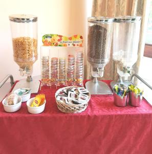 a red table with two blenders and bowls of food at Appart Hotel Corte HR in Corte