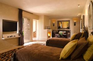 a hotel room with two beds and a television at Dar Sabra in Marrakech