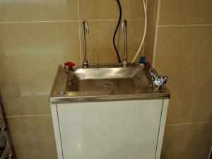 a sink in the corner of a bathroom at Hotel Seri Nilai in Nilai