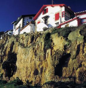 a house on top of a rocky mountain at Hotel Igeretxe in Getxo