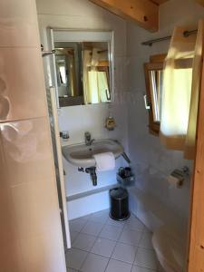 a bathroom with a sink and a mirror at Chalet Clochette 4 Valles-Verbier in La Tzoumaz +18 photos