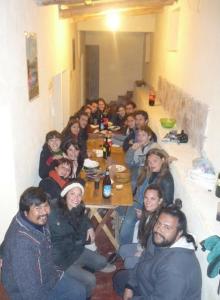 a group of people sitting around a long table at Alojamiento El Cardon Tilcara in Tilcara