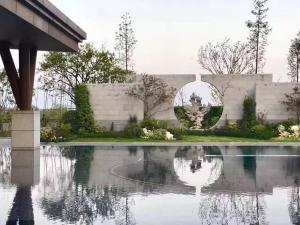 a reflecting pool in front of a building at Pullman Zhouzhuang in Kunshan