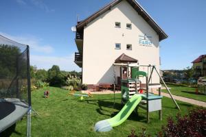 a playground in front of a house with a slide at Willa Faro in Jastrzębia Góra