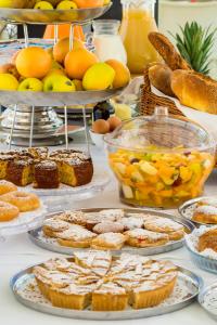 a table with various types of bread and other foods at Cave Bianche Hotel in Favignana