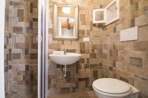 a bathroom with a toilet and a sink at HolidayMonopoli in Monopoli