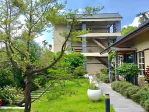 a house with a garden in front of it at Champs Yazuh B&B in Jiji