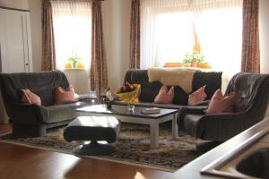 a living room with two couches and a coffee table at Auszeit-Wohnungen in Aidenbach