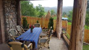 a blue table and chairs on a patio at Casa din Piatra in Poiana