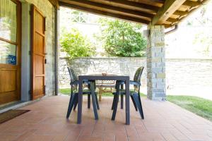 a table and chairs sitting on a patio at Villa La Verna in Chiusi della Verna