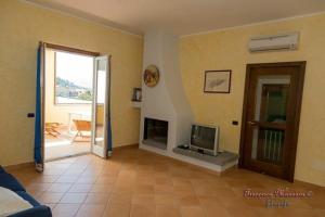 a living room with a fireplace and a television at B&B Villa I Nobili in Cava deʼ Tirreni