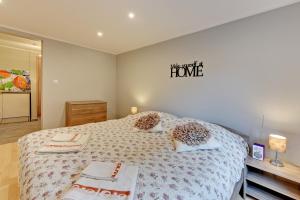 a bedroom with a large bed and a sign on the wall at Villa Arkodes in Gdańsk