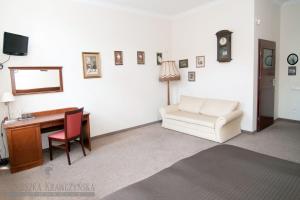 a living room with a desk and a couch and a chair at Pokoje Sopockie in Sopot +60 photos