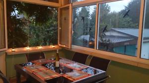 a table in a restaurant with two large windows at Gîte "La Baloise" in Colmar +16 photos