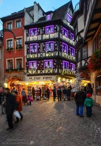 a large building with purple lights on a market at Gîte "La Baloise" in Colmar