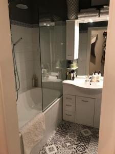 a bathroom with a shower and a tub and a sink at Apartment Lakeside in Salzburg