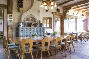 a dining room with a wooden table and chairs at Landhotel Wiesbauer in Füssen