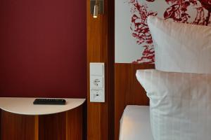 Postel nebo postele na pokoji v ubytování IBB Hotel Ingelheim