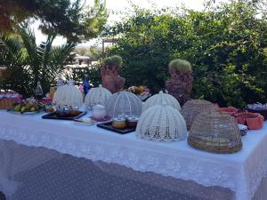 a white table with food and cages on it at Terre Di Vendicari in Noto
